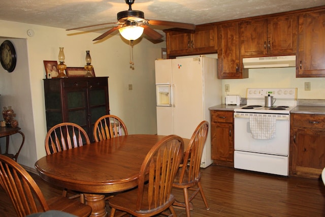 dining space with dark hardwood / wood-style floors, ceiling fan, and a textured ceiling