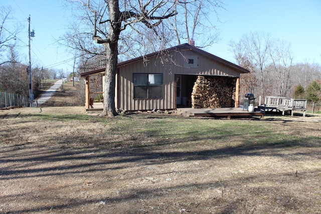 view of side of home featuring a wooden deck