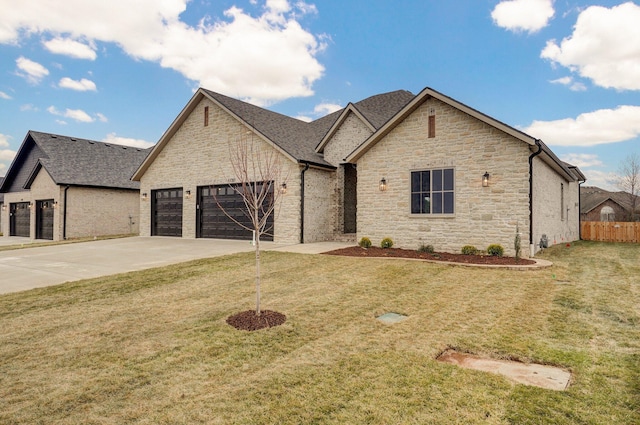 french provincial home featuring a garage and a front lawn