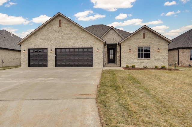 french country home with a front yard and a garage