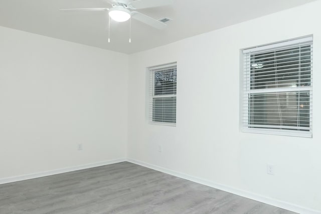 unfurnished room with hardwood / wood-style floors and ceiling fan