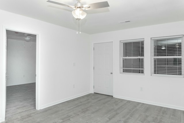 empty room featuring ceiling fan and light hardwood / wood-style flooring