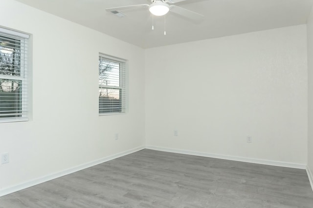 unfurnished room featuring hardwood / wood-style floors and ceiling fan