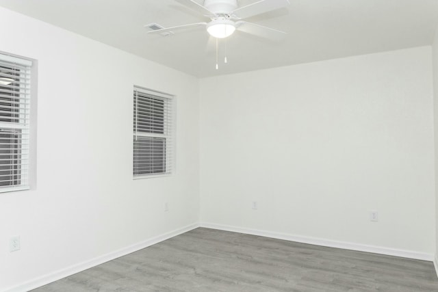 spare room with ceiling fan and hardwood / wood-style flooring