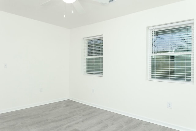 spare room with hardwood / wood-style floors and ceiling fan