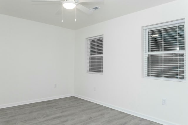 empty room featuring hardwood / wood-style floors and ceiling fan