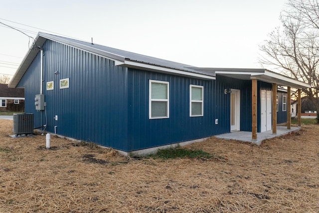 view of side of home featuring cooling unit