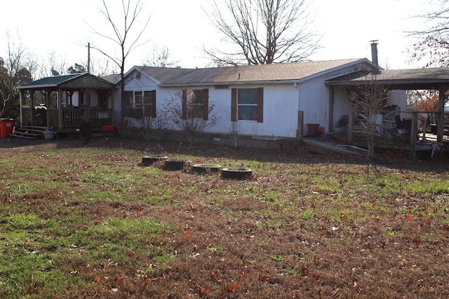 back of property featuring a lawn