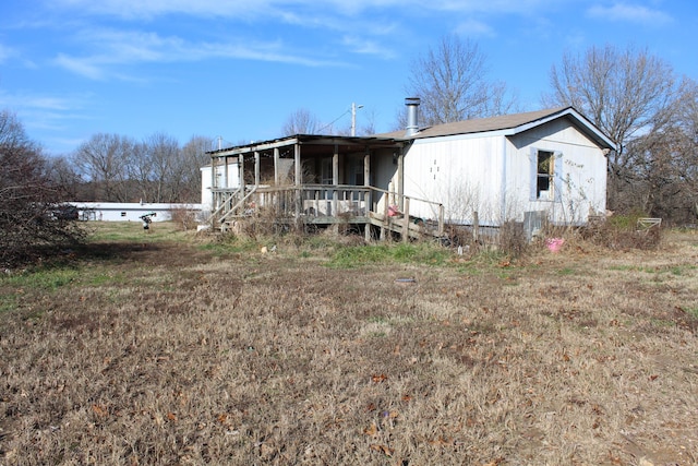 back of house featuring covered porch