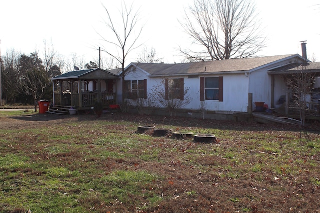 rear view of property with a lawn