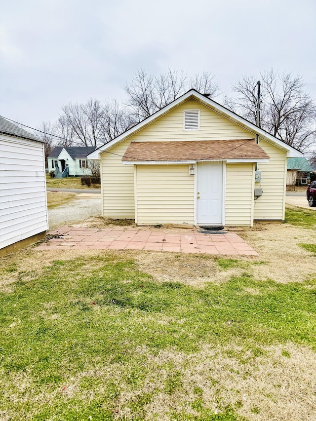 back of property featuring a lawn