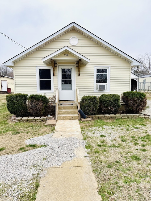 bungalow-style house featuring cooling unit