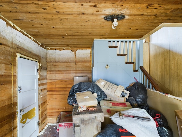 interior space featuring wood ceiling and wooden walls