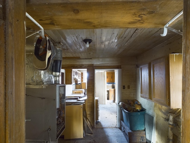 hall with wood walls, wooden ceiling, and washer / dryer