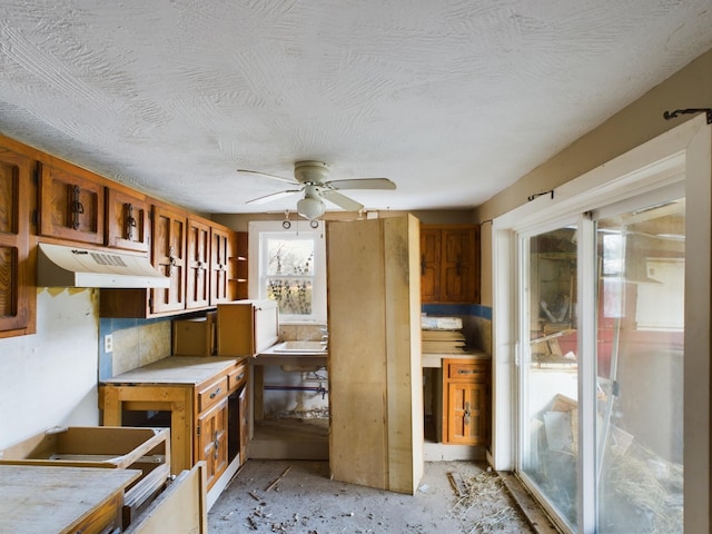 kitchen featuring a textured ceiling and ceiling fan