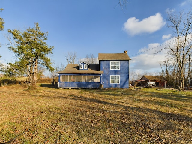 back of house featuring a sunroom and a yard