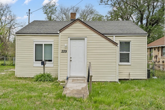 229 N Scenic Ave, Springfield, MO 65802 - exterior space with fence, a front lawn, a chimney, and roof with shingles