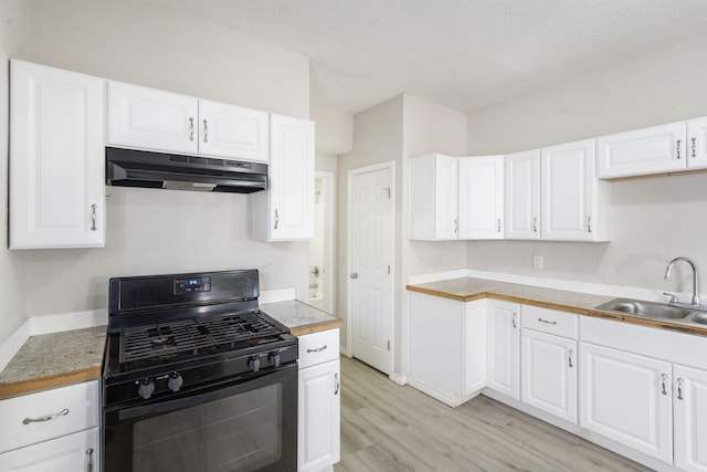 kitchen with black range with gas stovetop, sink, light hardwood / wood-style flooring, a textured ceiling, and white cabinetry