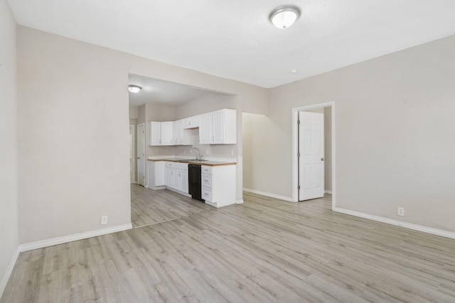 unfurnished living room featuring light wood-type flooring and sink