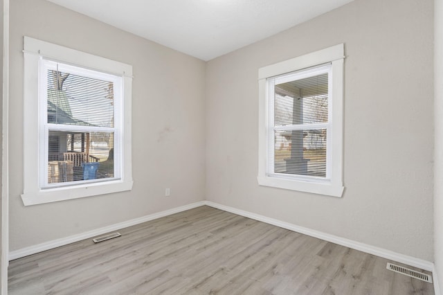 empty room with light hardwood / wood-style flooring