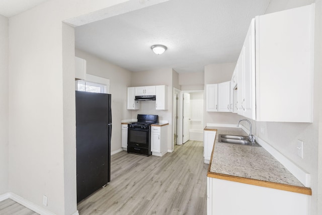 kitchen featuring black appliances, sink, light hardwood / wood-style flooring, a textured ceiling, and white cabinetry