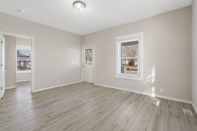 spare room with light wood-type flooring