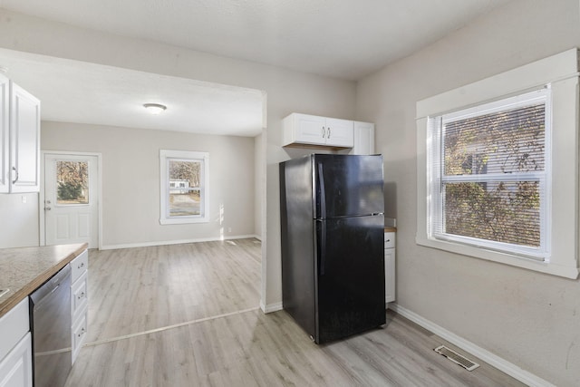 kitchen featuring white cabinetry, dishwasher, black refrigerator, and light hardwood / wood-style flooring