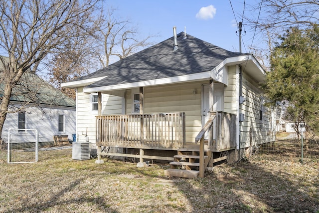 back of house with central AC unit