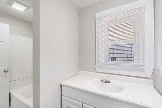 bathroom featuring vanity and a textured ceiling