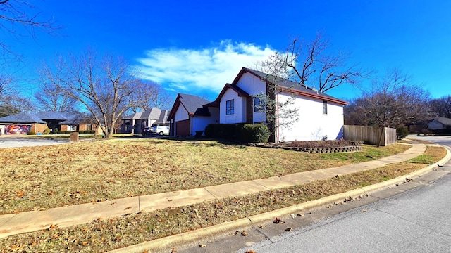 view of side of home featuring a lawn