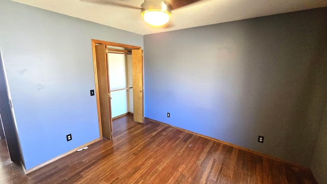 spare room featuring ceiling fan and dark hardwood / wood-style flooring