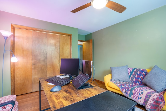 home office with ceiling fan and light hardwood / wood-style floors