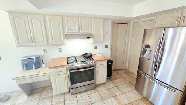 kitchen with light tile patterned floors and appliances with stainless steel finishes