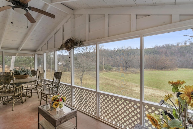 unfurnished sunroom with ceiling fan and lofted ceiling with beams