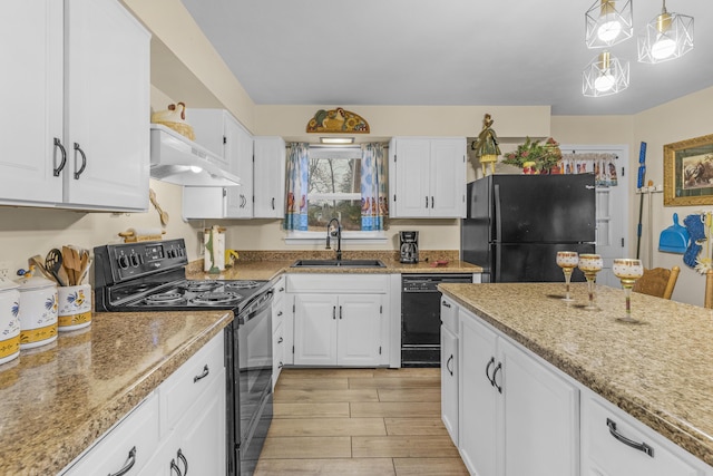 kitchen with pendant lighting, exhaust hood, black appliances, sink, and white cabinetry