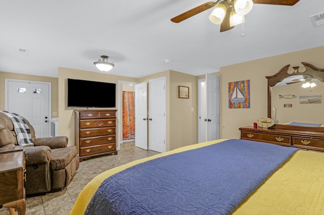 tiled bedroom with ceiling fan