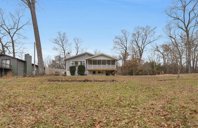 exterior space featuring a front lawn and a sunroom