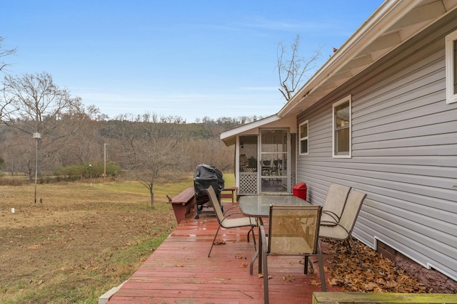 wooden terrace with grilling area and a sunroom