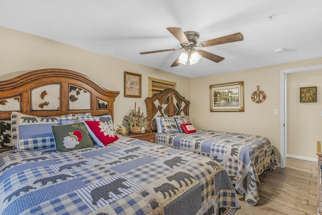 bedroom featuring ceiling fan and light hardwood / wood-style flooring