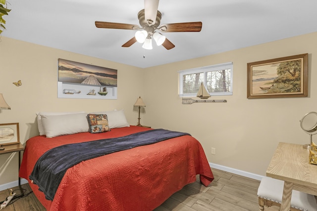 bedroom with ceiling fan and light hardwood / wood-style floors