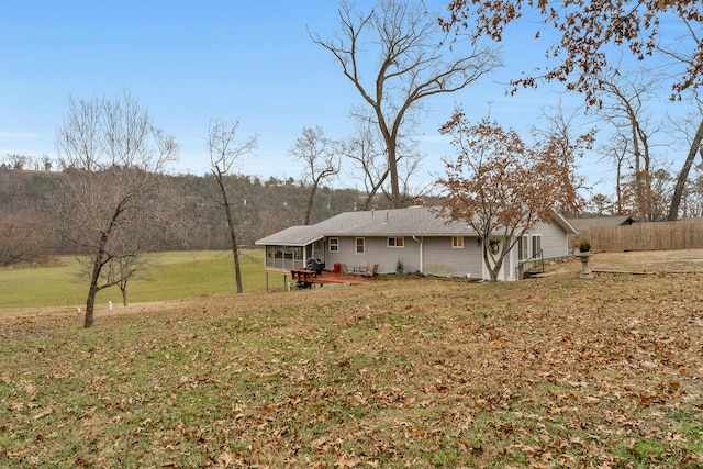 view of yard with a sunroom and a wooden deck