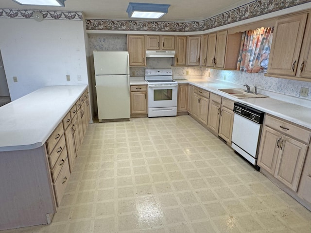 kitchen with kitchen peninsula, white appliances, and sink