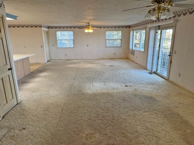 empty room featuring ceiling fan and light carpet