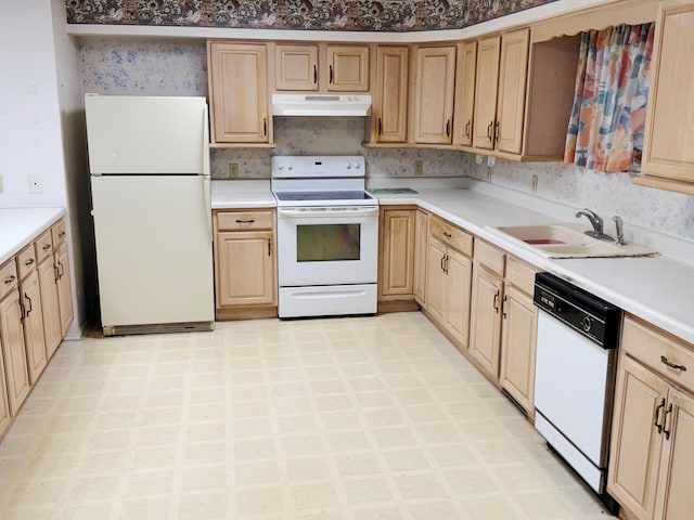 kitchen featuring light brown cabinetry, white appliances, and sink