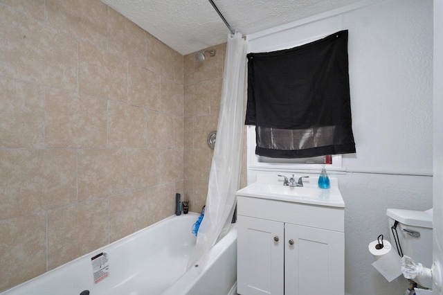 bathroom featuring vanity, shower / bath combo, and a textured ceiling