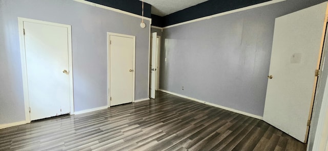 unfurnished bedroom with hardwood / wood-style flooring