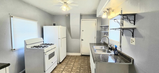 kitchen featuring ceiling fan, white appliances, and sink