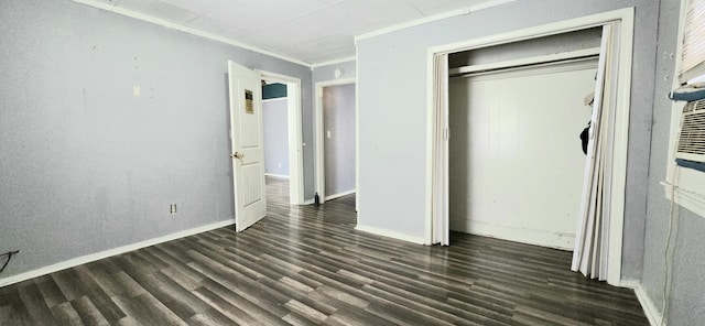 unfurnished bedroom featuring crown molding, dark wood-type flooring, and a closet