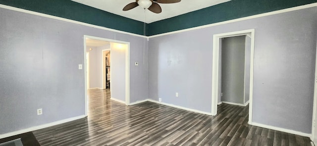 empty room featuring dark hardwood / wood-style flooring and ceiling fan