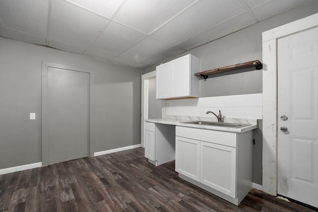 kitchen with white cabinets, a paneled ceiling, dark hardwood / wood-style floors, and sink